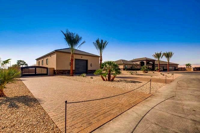 Home exterior with palms and oversized RV garage door